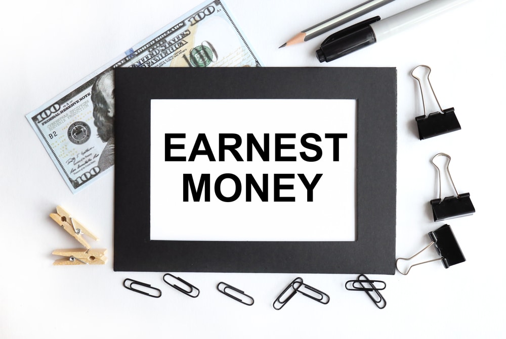 EarnestMoneyTextOnWhitePaperOnBlackEnvelope